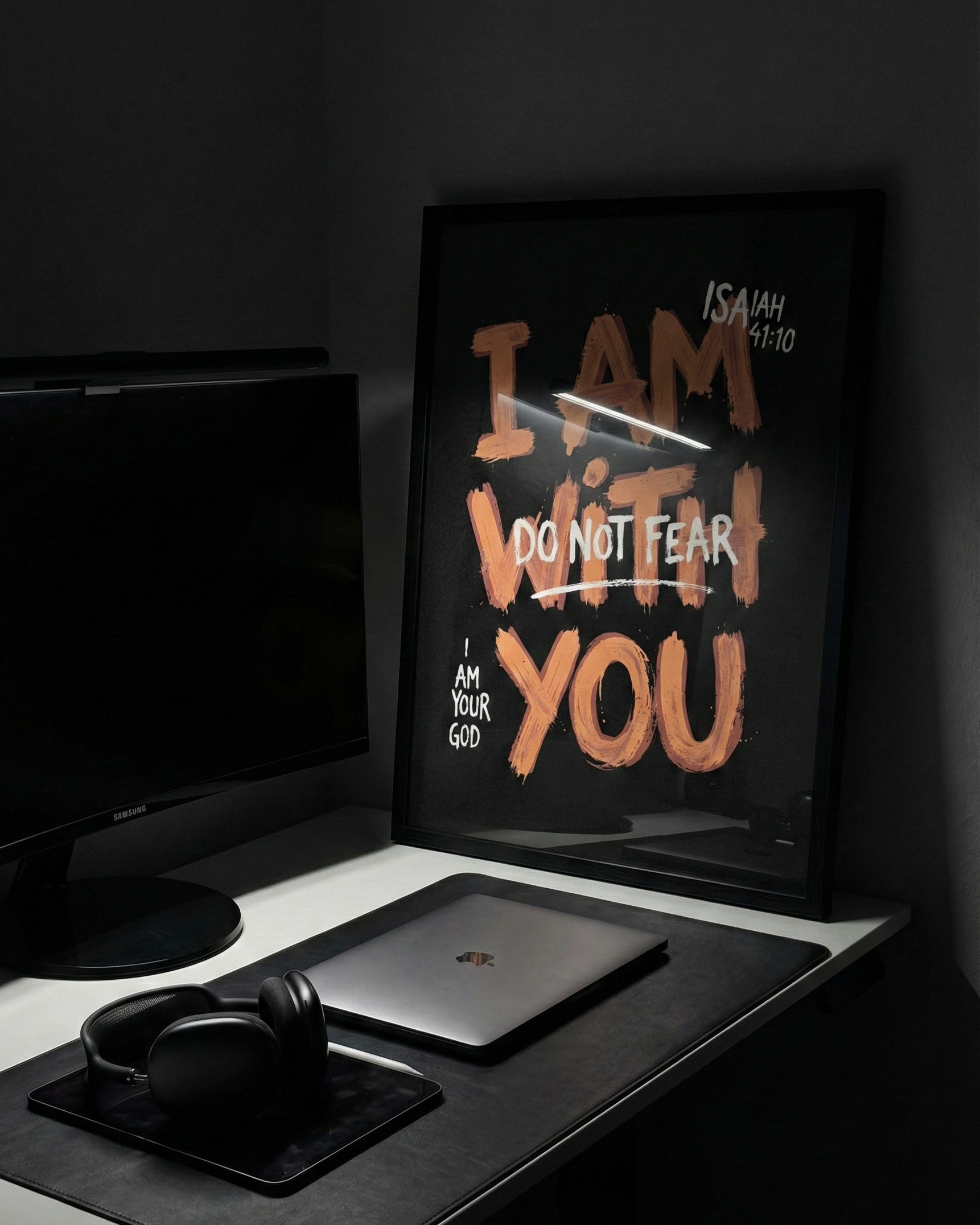 isaiah 41:10 dark poster standing on clean desk setup with flash bright light.